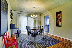 Simple yellow green family room with a chalkboard and kids chai