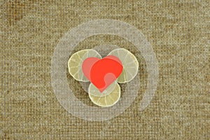 simplicity love: red heart lies on a self-sewed a linen fabric Golden brown color of natural linen, decorated with 3 slices of