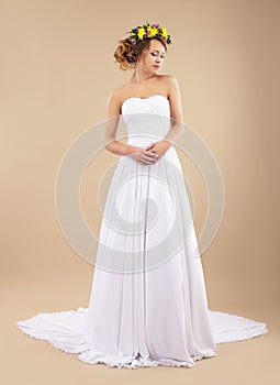 Simplicity. Minimalism. Bride with Wildflowers in Classic Dress