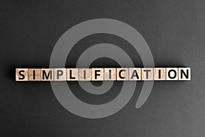 Simplification - word from wooden blocks with letters photo