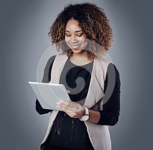 Simplifying business operations with smart technology. Studio shot of a young businesswoman using a digital tablet