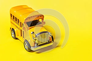 Simply design yellow classic toy car school bus isolated on yellow colorful background. Safety daily transport for kids. Back to