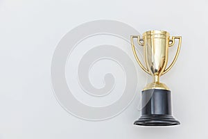 Simply flat lay design winner or champion gold trophy cup isolated on white background. Victory first place of competition.