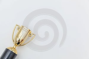 Simply flat lay design winner or champion gold trophy cup isolated on white background. Victory first place of competition.