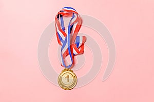 Simply flat lay design winner or champion gold trophy medal isolated on pink colorful background. Victory first place of