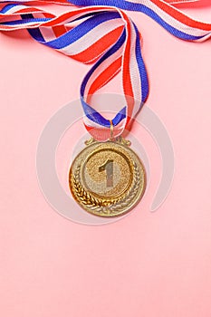 Simply flat lay design winner or champion gold trophy medal isolated on pink colorful background. Victory first place of