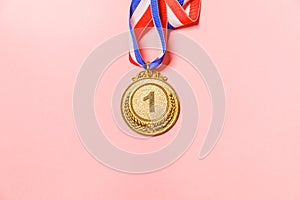 Simply flat lay design winner or champion gold trophy medal isolated on pink colorful background. Victory first place of