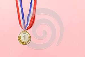 Simply flat lay design winner or champion gold trophy medal isolated on pink colorful background. Victory first place of