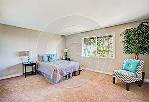 Simply furnished bedroom with colorful pillows