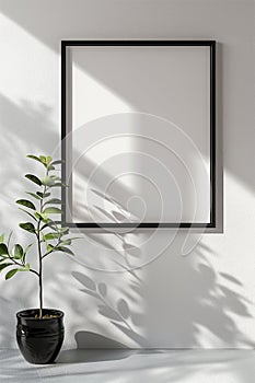 The simulation of a black frame with a white coating contrasts with the plain white wall. and simple furniture