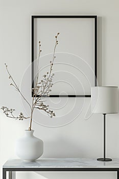 The simulation of a black frame with a white coating contrasts with the plain white wall. and simple furniture