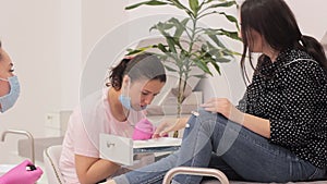 Simultaneous manicure and pedicure in beauty salon