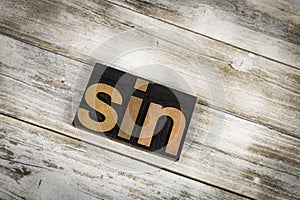 Sin Letterpress Word on Wooden Background photo