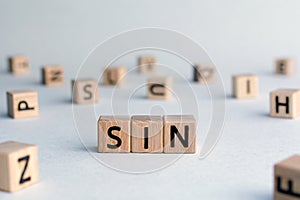 sin - word from wooden blocks with letters