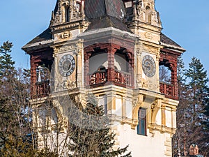 Architecture detail with one of the Peles Castle towers. Castle tower with a clock