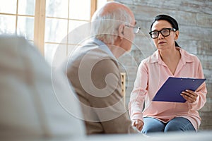 Sincere caregiver participating in senior mans life