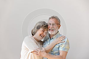 Sincere laughing bonding middle aged couple feeling happy.