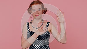 Sincere responsible redhead woman raising hand to take oath promising to be honest and to tell truth