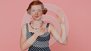 Sincere responsible redhead woman raising hand to take oath promising to be honest and to tell truth