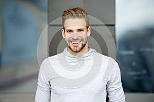Sincere smile concept. Man with perfect brilliant smile unshaven face urban background. Guy happy emotional expression