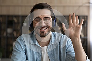 Sincere smiling young businessman holding video call conversation.