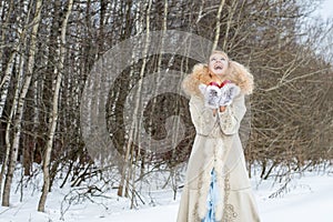 Sincerely laughing young woman in a winter forest