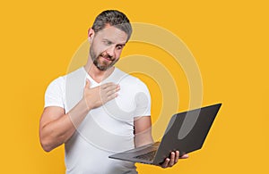 sincerely man programmer in studio. man programmer with laptop isolated on yellow background.