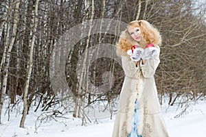 Sincerely smiling young woman in a winter forest