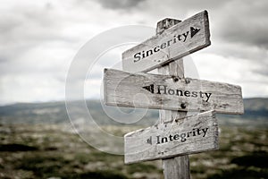 sincerity honesty integrity text engraved on old wooden signpost outdoors in nature