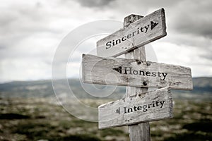 sincerity honesty integrity text engraved on old wooden signpost outdoors in nature photo