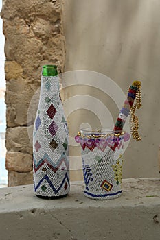 Sindhi artisan handicrafts: beaded casings for bottle and mortar and pestle set