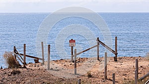 Sing posted on a edge of a cliff of Cape Kiwanda read `Danger` and `Do not go beyond this point`