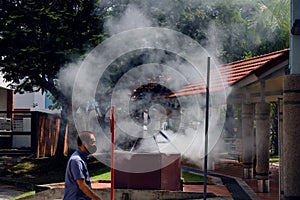 Singapore Aug2021 Heavy smoke from concrete burner as residents burn joss paper money as offerings to the dead during 7th month