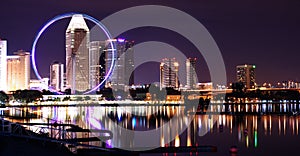 Singapore city lights and ferris wheel photo