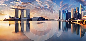 Singapore city skyline at sunset with bridge