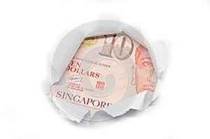 Singapore currency peeking through white paper