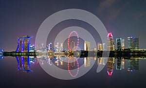 Singapore Downtown skyline at night with reflection. Financial district and business centers in technology smart urban city in