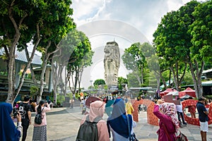 Merlion Statue on Sentosa Island and tourists in Singapore.