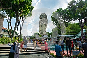 Merlion Statue on Sentosa Island and tourists in Singapore.