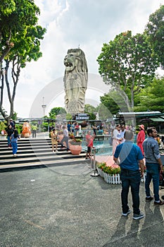 Merlion Statue on Sentosa Island and tourists in Singapore.