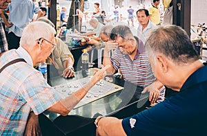 Singapore-09 JUN 2018:Chinese old man play chess in the Singapore China town open plaza