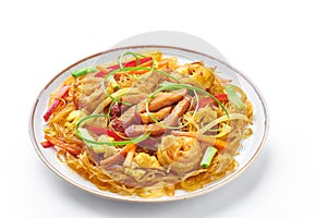 Singapore Mei Fun in plate isolated on white background. Singapore Noodles is chinese cuisine dish. Chinese food