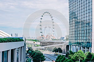 Cars traffic on Sheares ave with Singapore Flyer giant ferris wheel on background