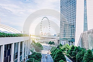 Cars traffic on Sheares ave with Singapore Flyer giant ferris wheel on background