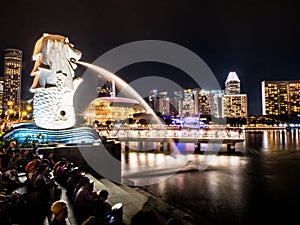 SINGAPORE - NOV 22, 2018: The Merlion fountain spouts water in front of the Marina Bay Sands hotel in Singapore. This fountain is