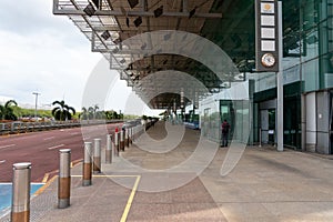 SINGAPORE, SINGAPORE - Mar 30, 2020: Outside Changi Airport terminal 3 middle of afternoon with almost no people