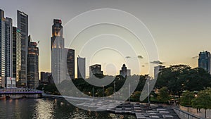 Singapore skyscrapers skyline with white Anderson Bridge near esplanade park day to night timelapse.