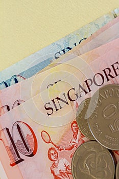 Singaporean coins on a background of notes.