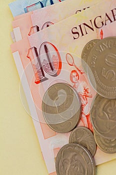 Singaporean coins on a background of notes.