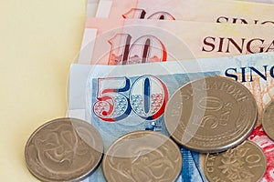 Singaporean coins on a background of notes.